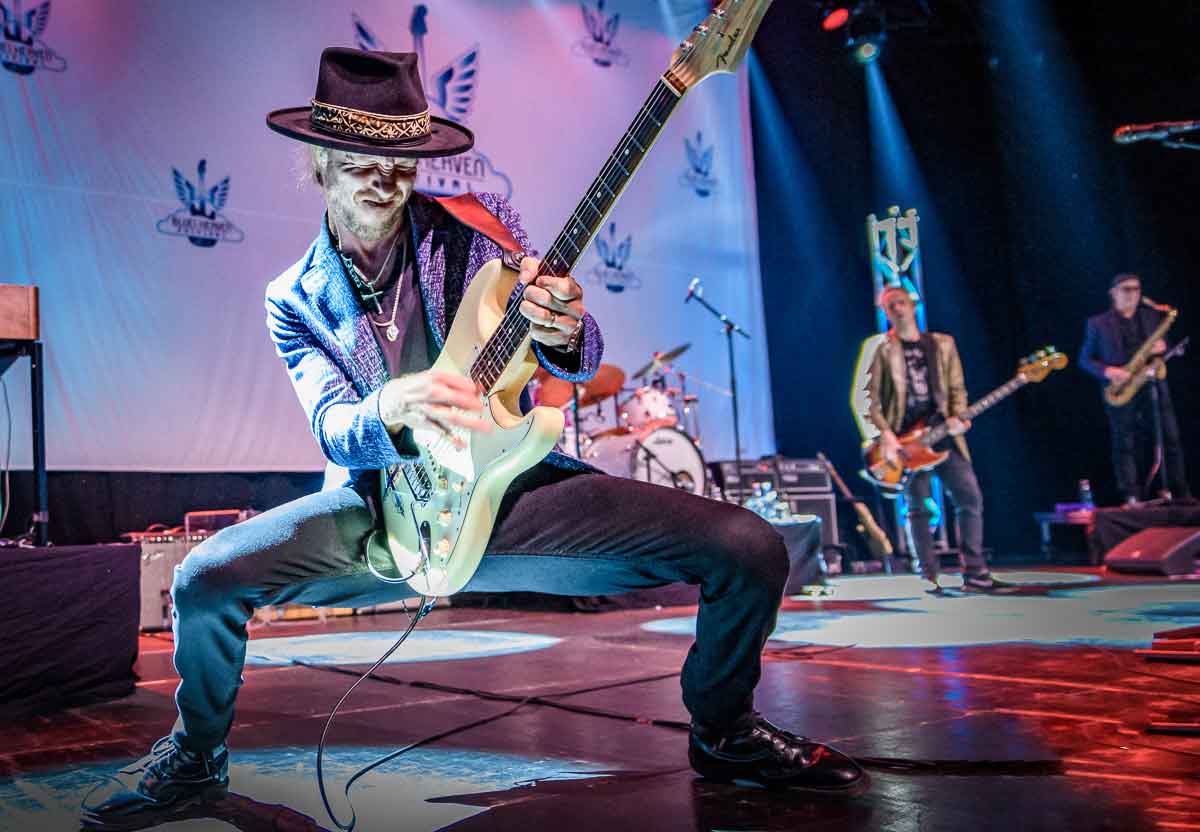 a man playing a guitar on a stage